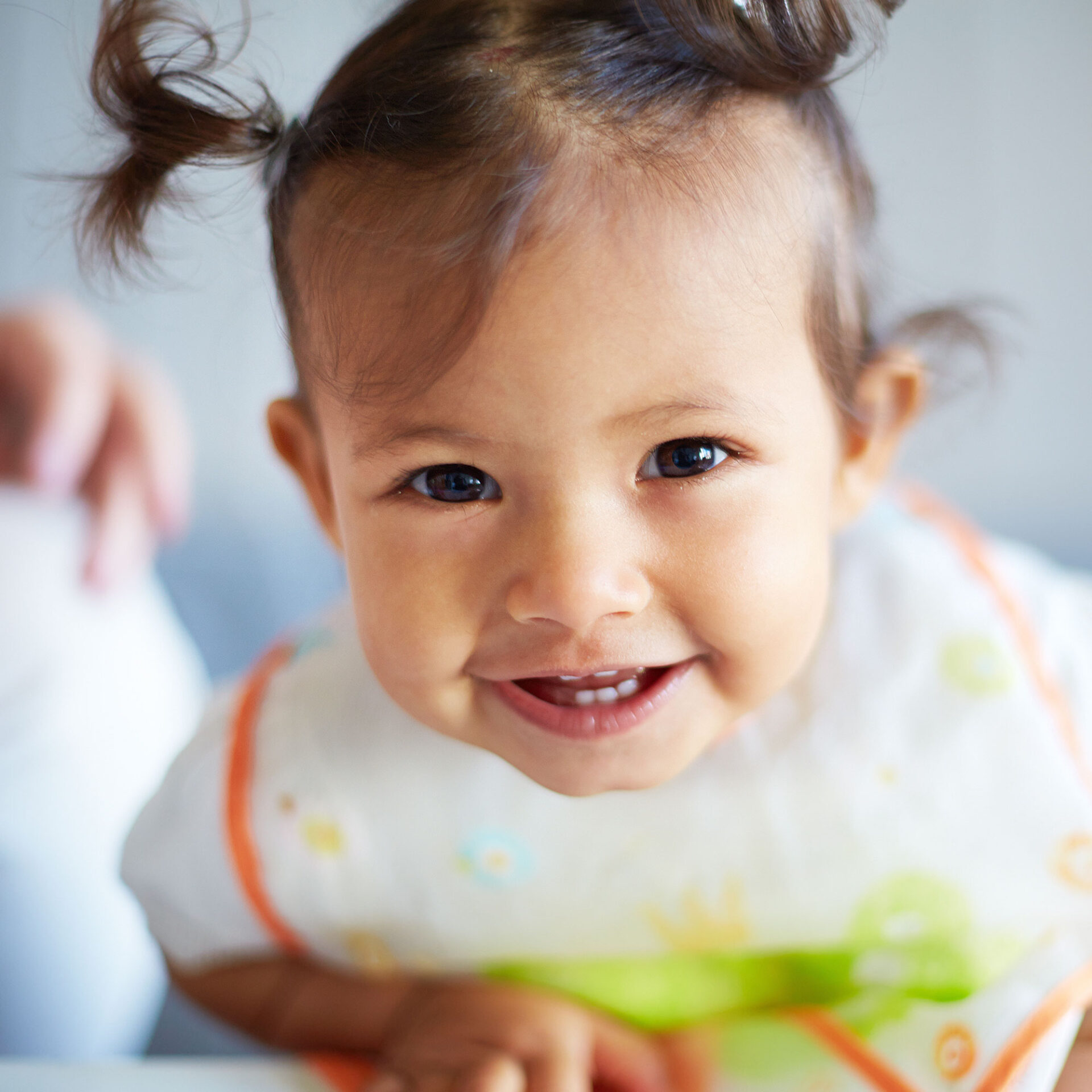 a smiling baby wearing a bib