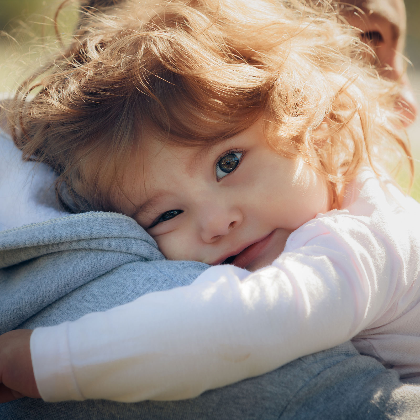 girl-resting-dads-shoulder A young girl rests on her dad's shoulder